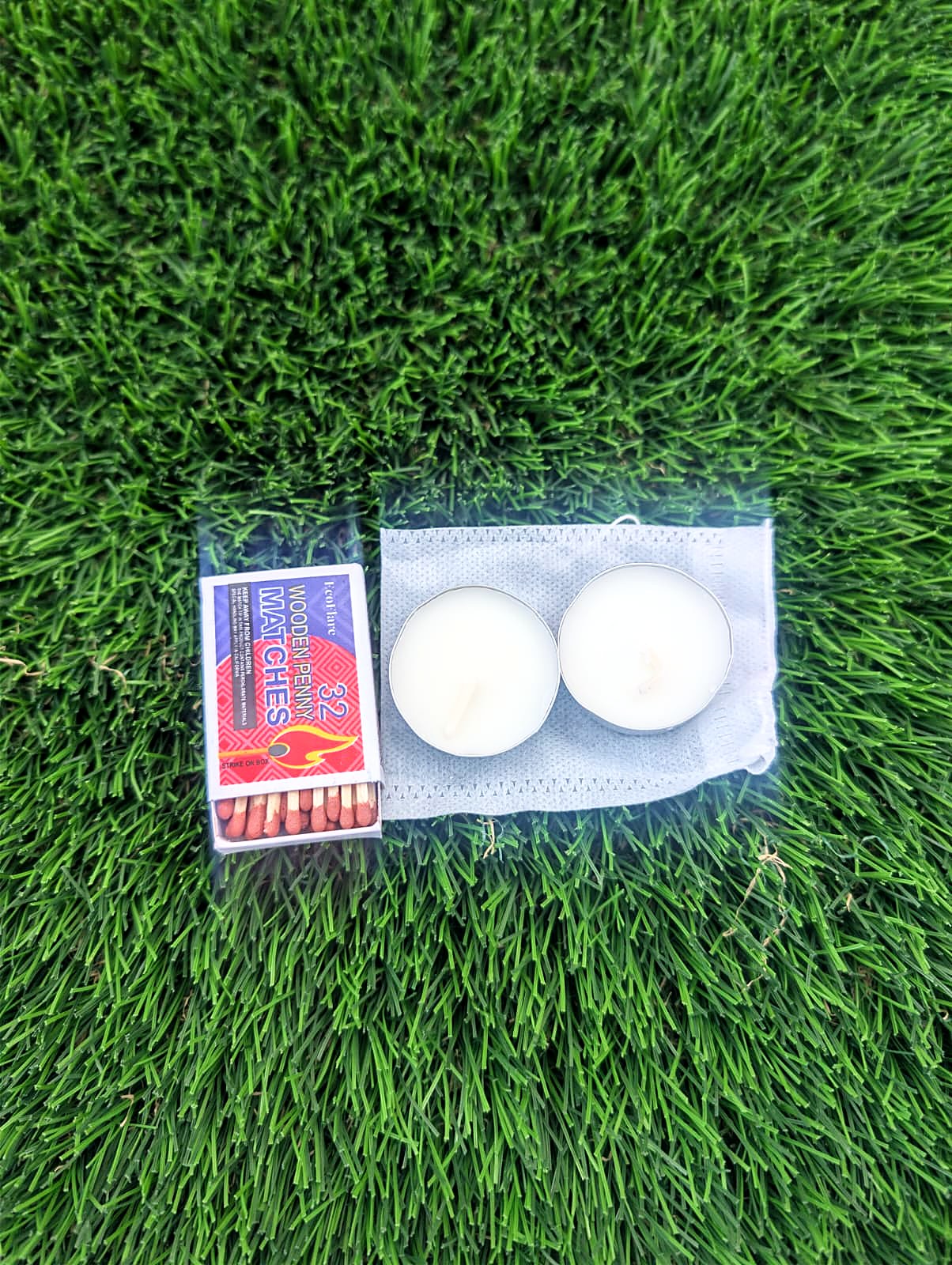 Tea lights and matches on grass